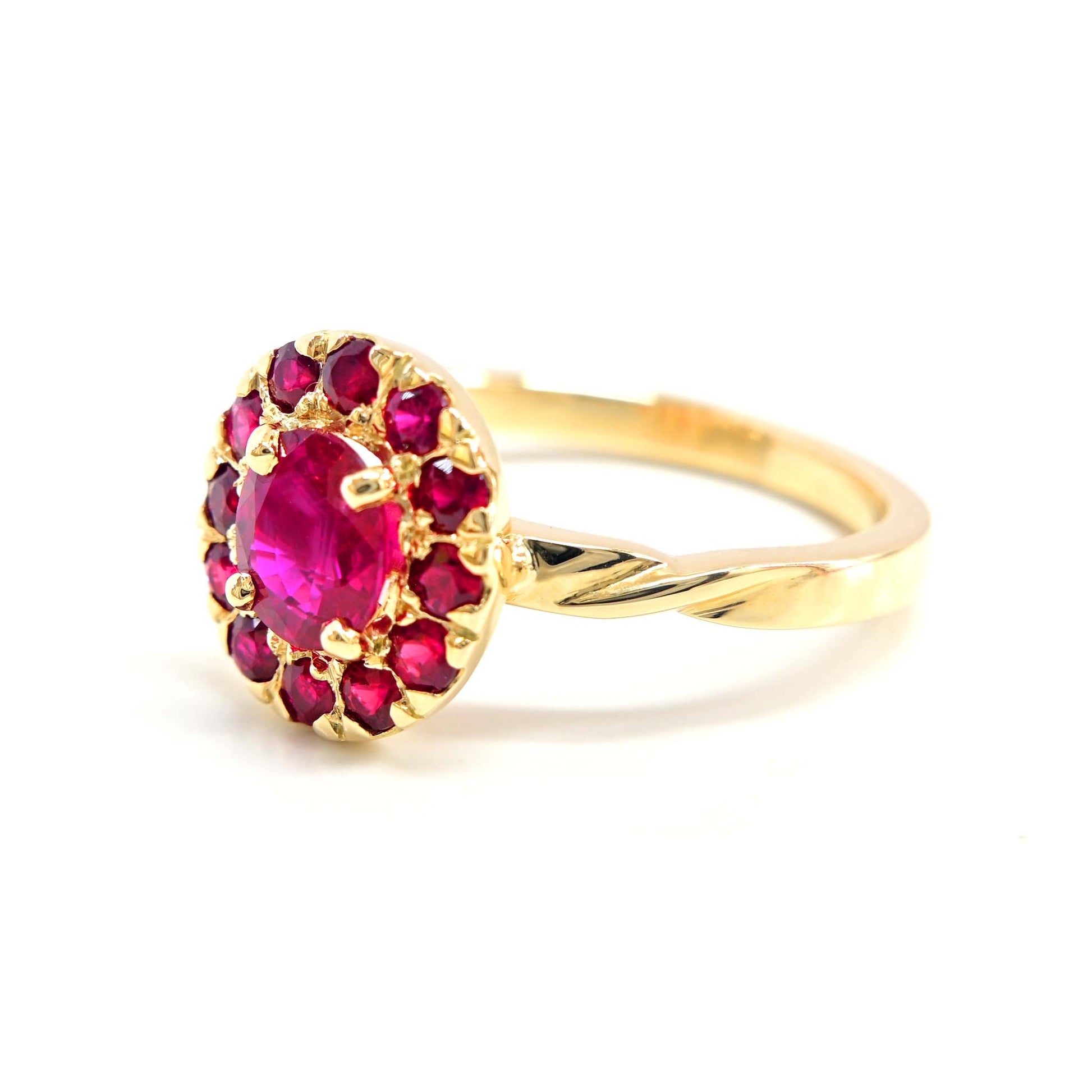 Vibrant ruby gemstone framed by a delicate halo of small rubies, exuding timeless beauty.