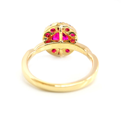 Modern ruby ring with a minimalist halo of rubies in yellow gold.