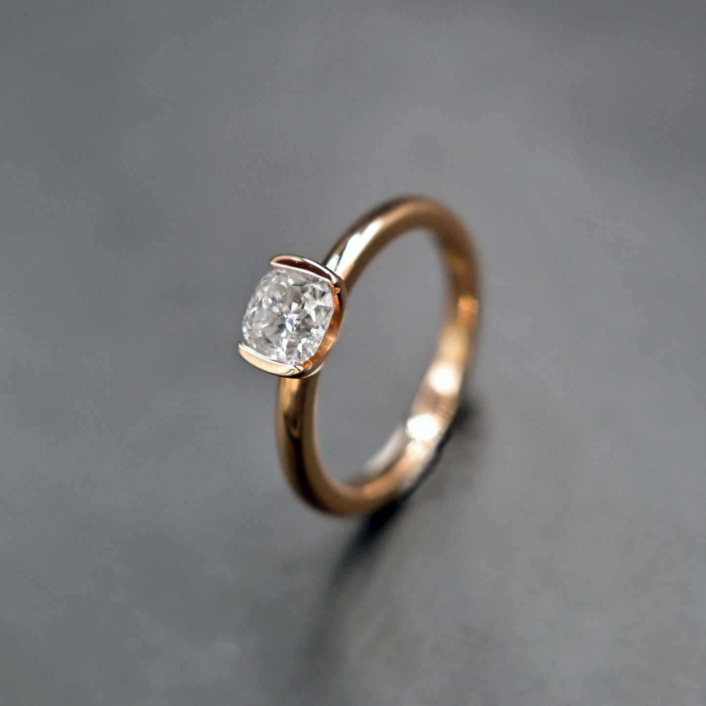 Moissanite rose gold ring in half-bezel setting