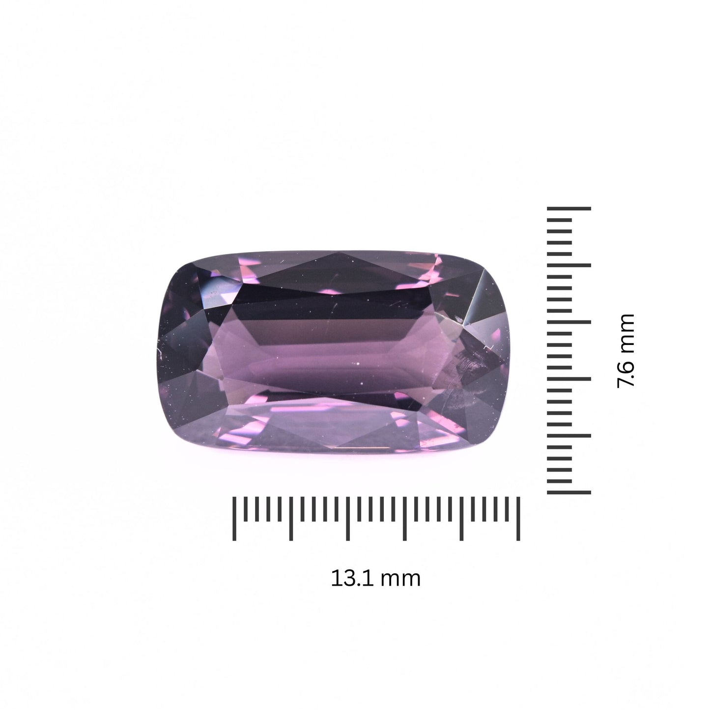 A 5.69-carat cushion-cut violet spinel gemstone from Burma, displaying vivid purple and pink undertones against a white background.