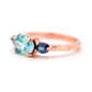 Side view of this beautiful ring with blue zircon and blue sapphires in rosegold