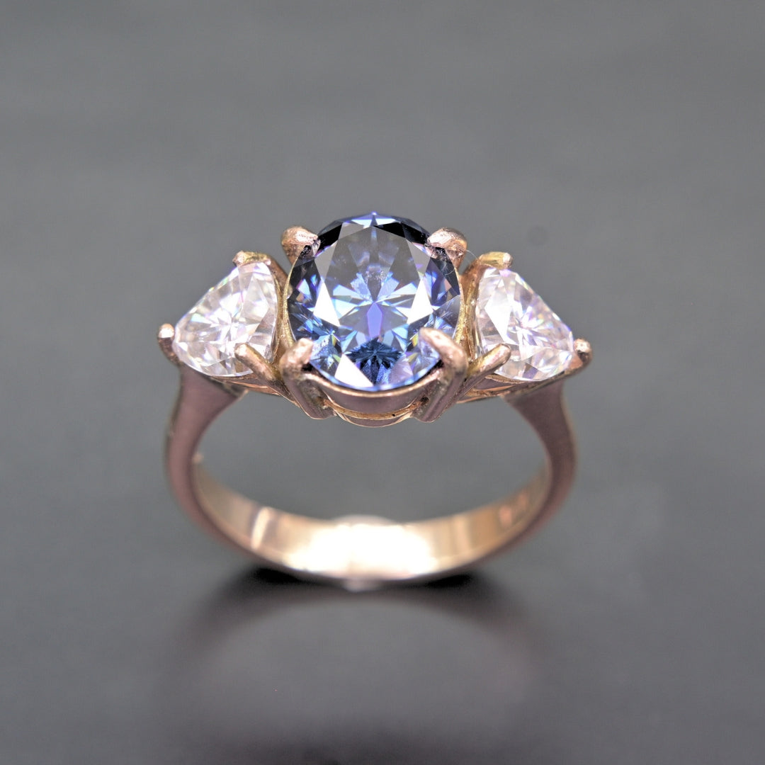 Oval Blue Moissanite Ring in 14K Gold Three-Stone Design