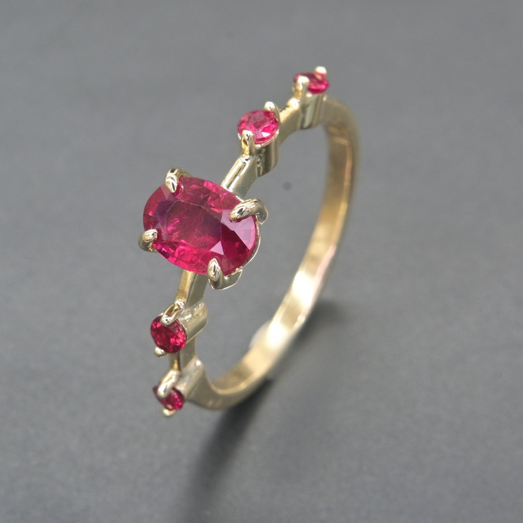 Anniversary ruby ring in 14K gold with oval and round rubies