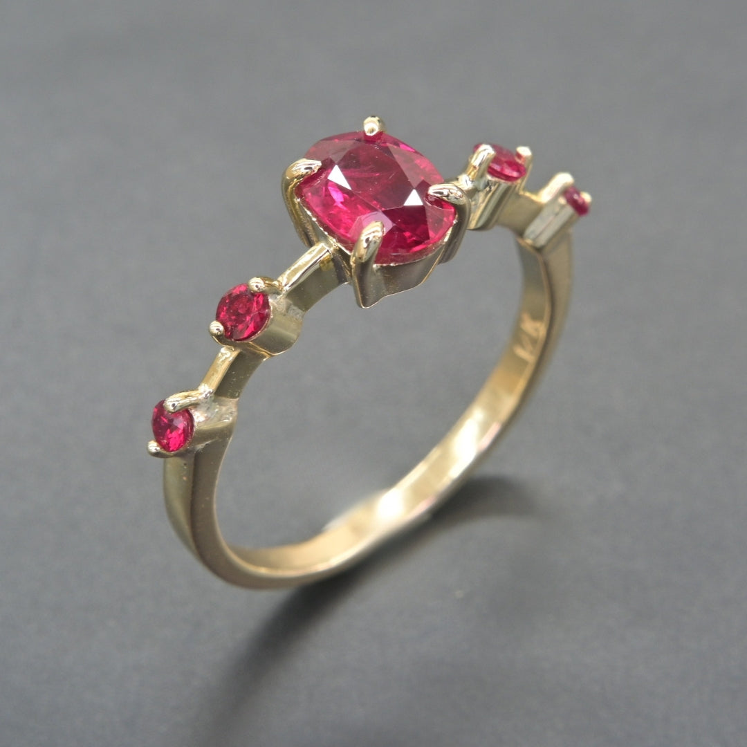 Ruby cascade ring in solid 14K gold with side ruby accents