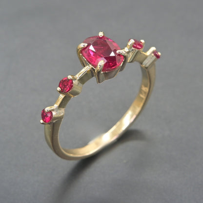 Ruby cascade ring in solid 14K gold with side ruby accents