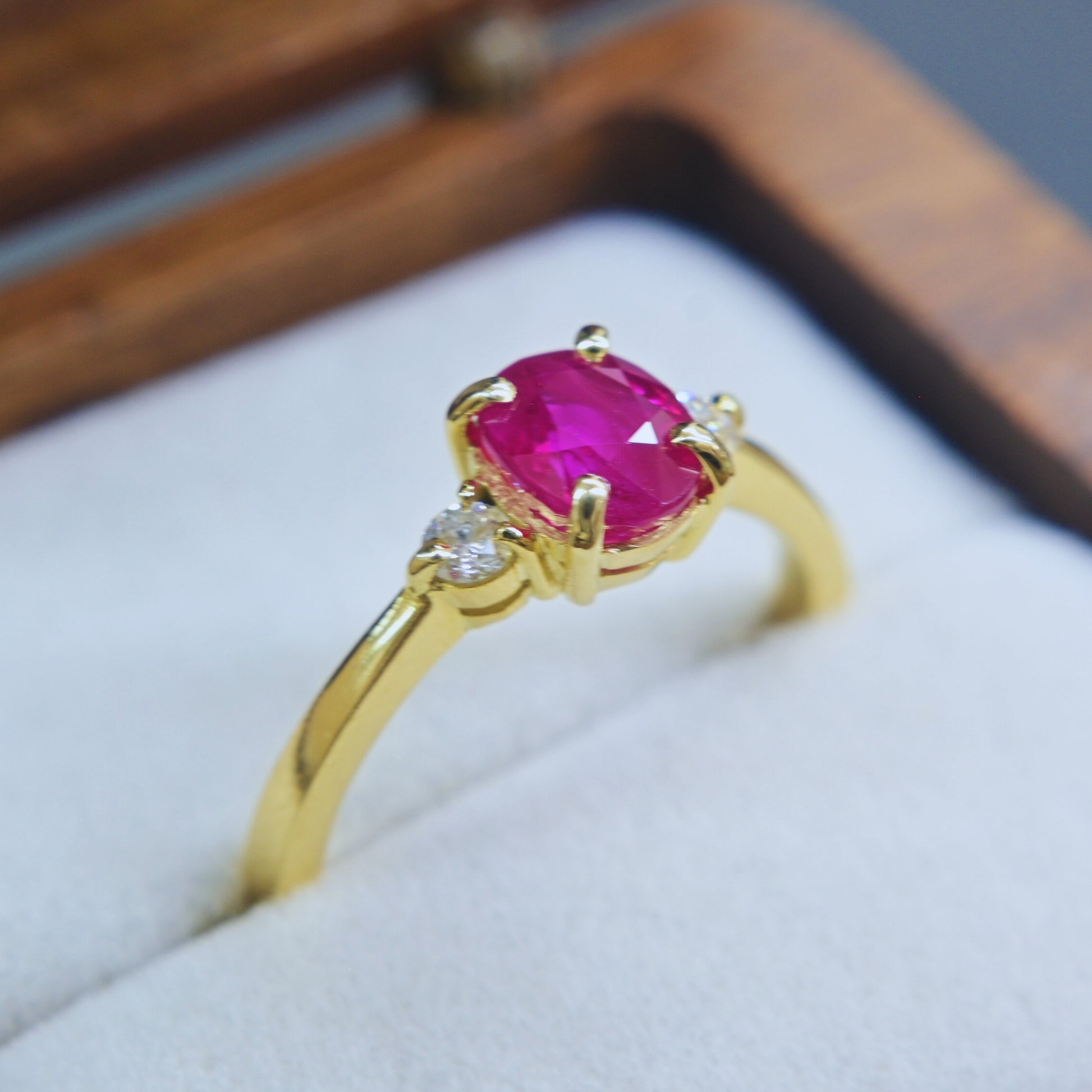 Ruby engagement ring in 18K yellow gold with two brilliant cut diamonds