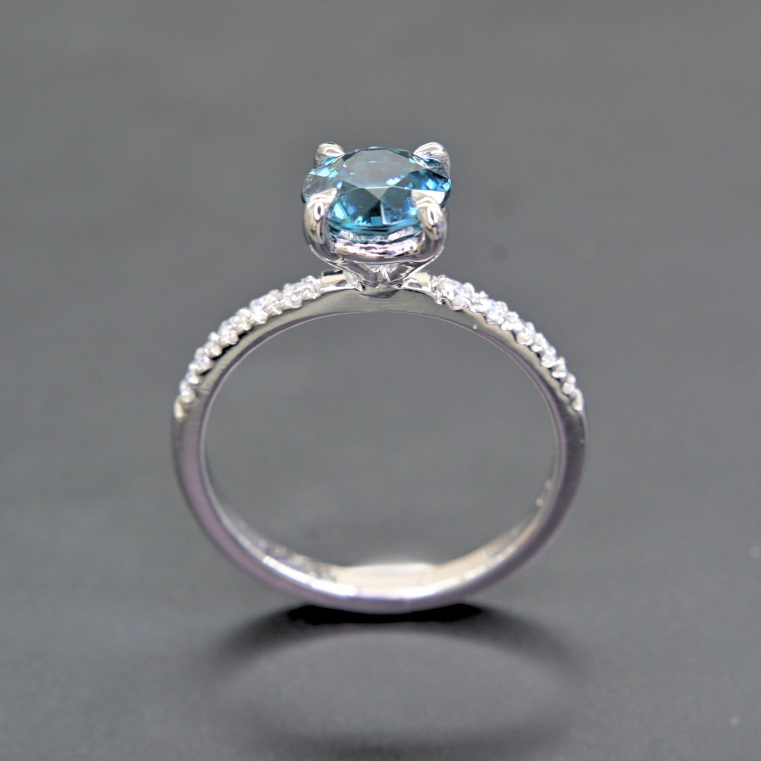 Natural blue zircon ring with white moissanites close-up