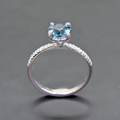 Natural blue zircon ring with white moissanites close-up