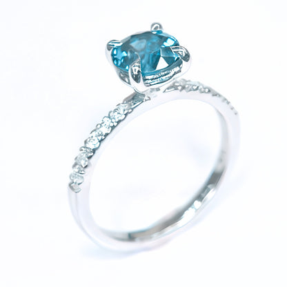 Round blue zircon ring with moissanite accents in 18K white gold