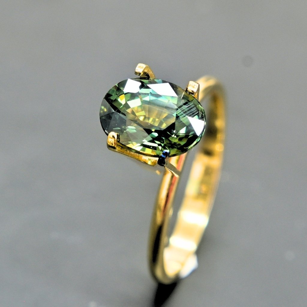 Premium Thai green sapphire displaying deep green and teal hues in natural light