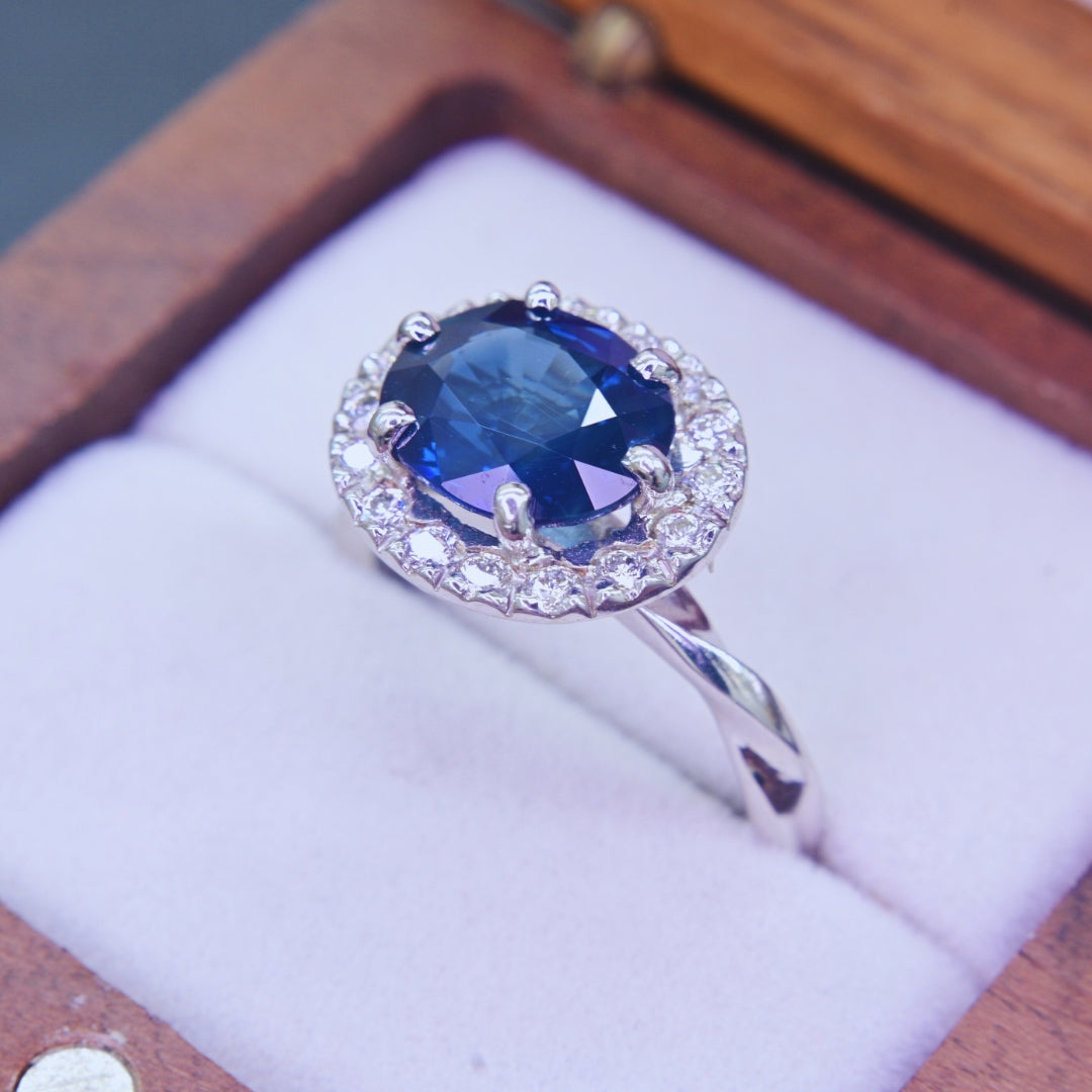 Natural blue sapphire engagement ring with diamond halo in 18K white gold