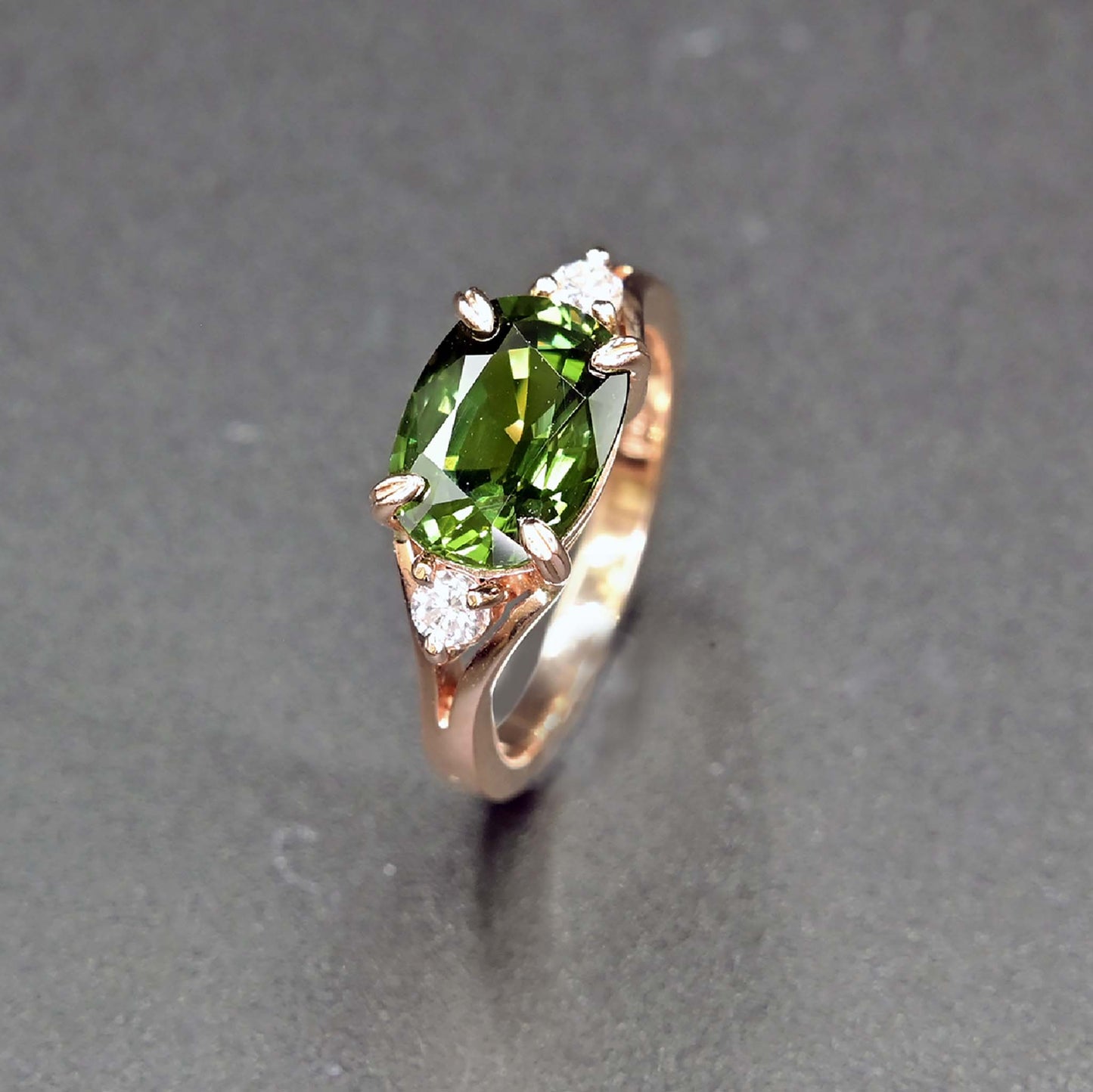 Green sapphire ring with two diamonds in rose gold setting