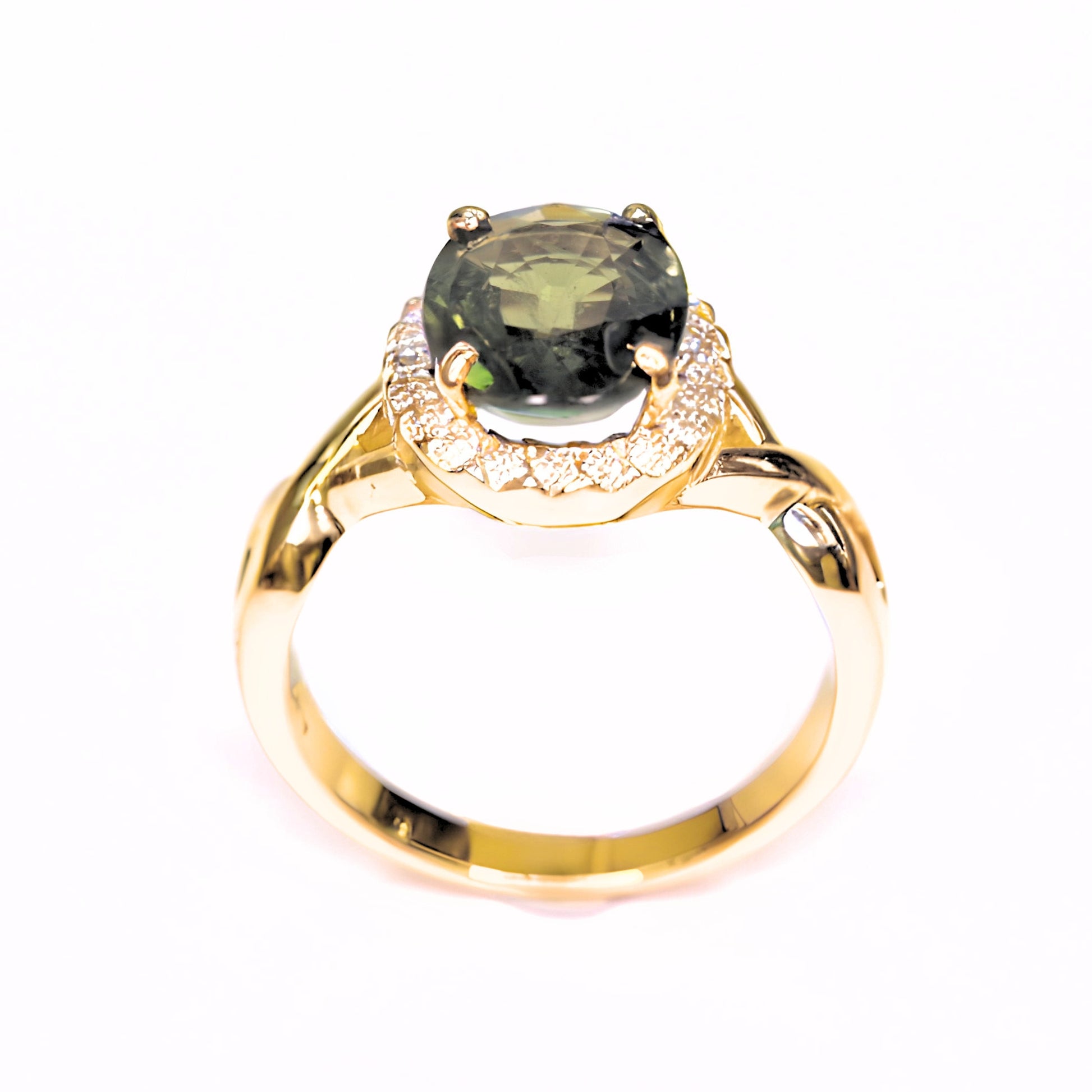 Close-up of green sapphire diamond halo ring showing handcrafted gold details