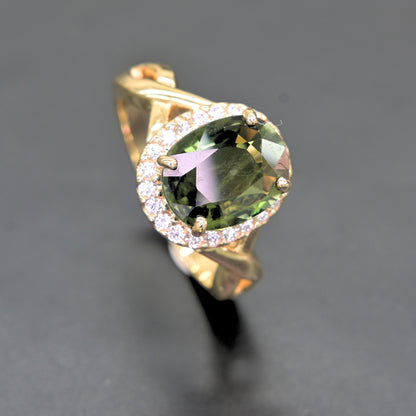 Oval green sapphire ring with diamond halo set in 14K yellow gold