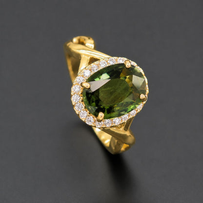 Fine jewelry green sapphire diamond halo ring in 14K yellow gold with an oval natural gemstone, sophisticated artisan-crafted statement ring for women.