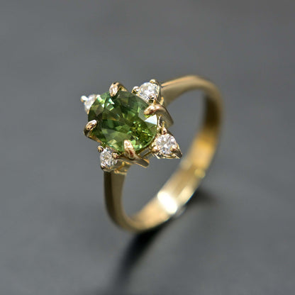 14k gold engagement ring with a beautiful green sapphire center stone and sparkling diamond accents.