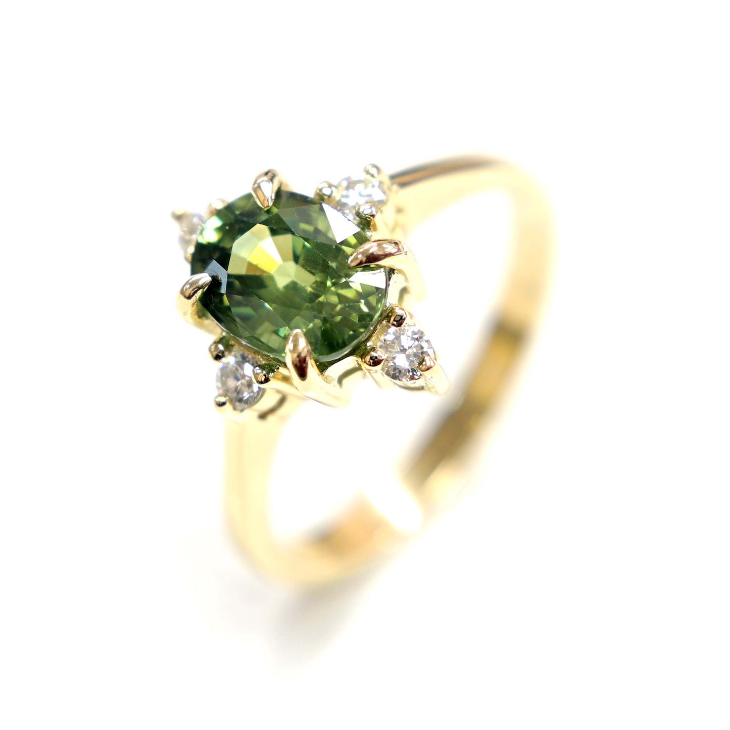 14k gold engagement ring with a beautiful green sapphire center stone and sparkling diamond accents.