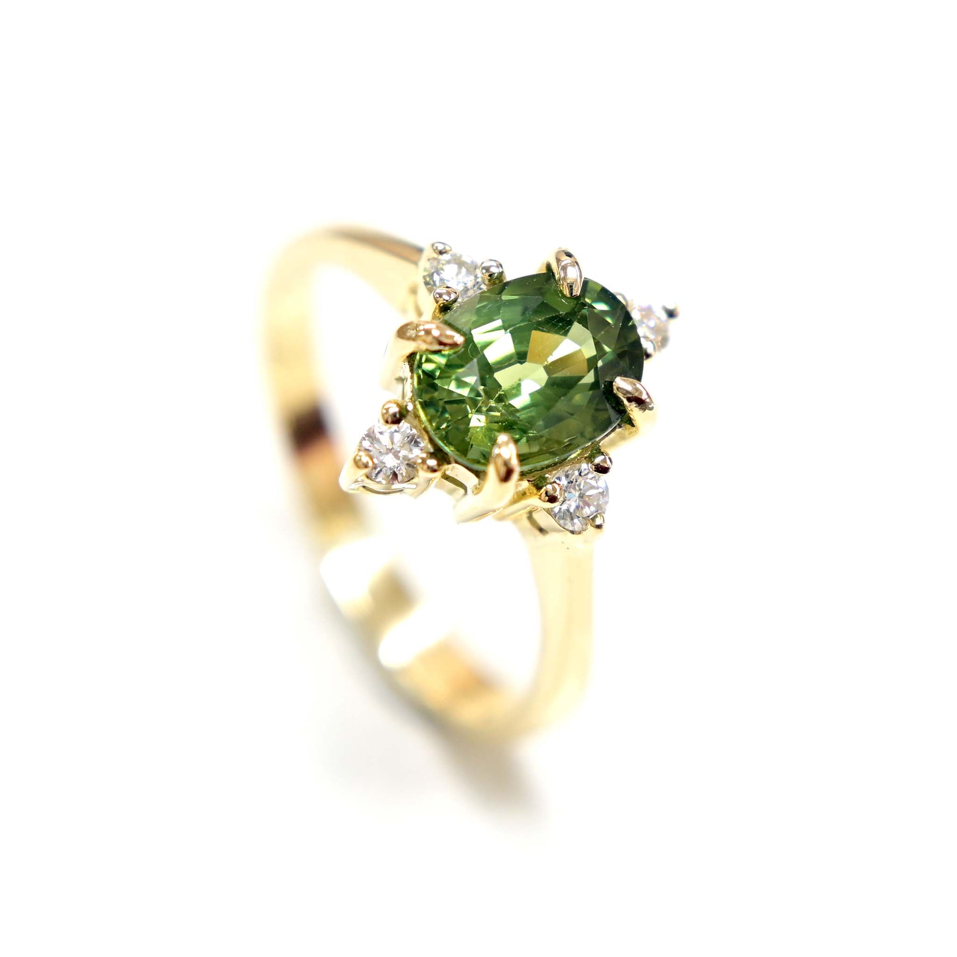 14k gold engagement ring with a beautiful green sapphire center stone and sparkling diamond accents.