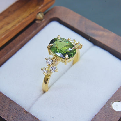 Oval cut natural green sapphire engagement ring with diamond accents in yellow gold