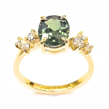 Sapphire engagement ring with green sapphire center and diamond details