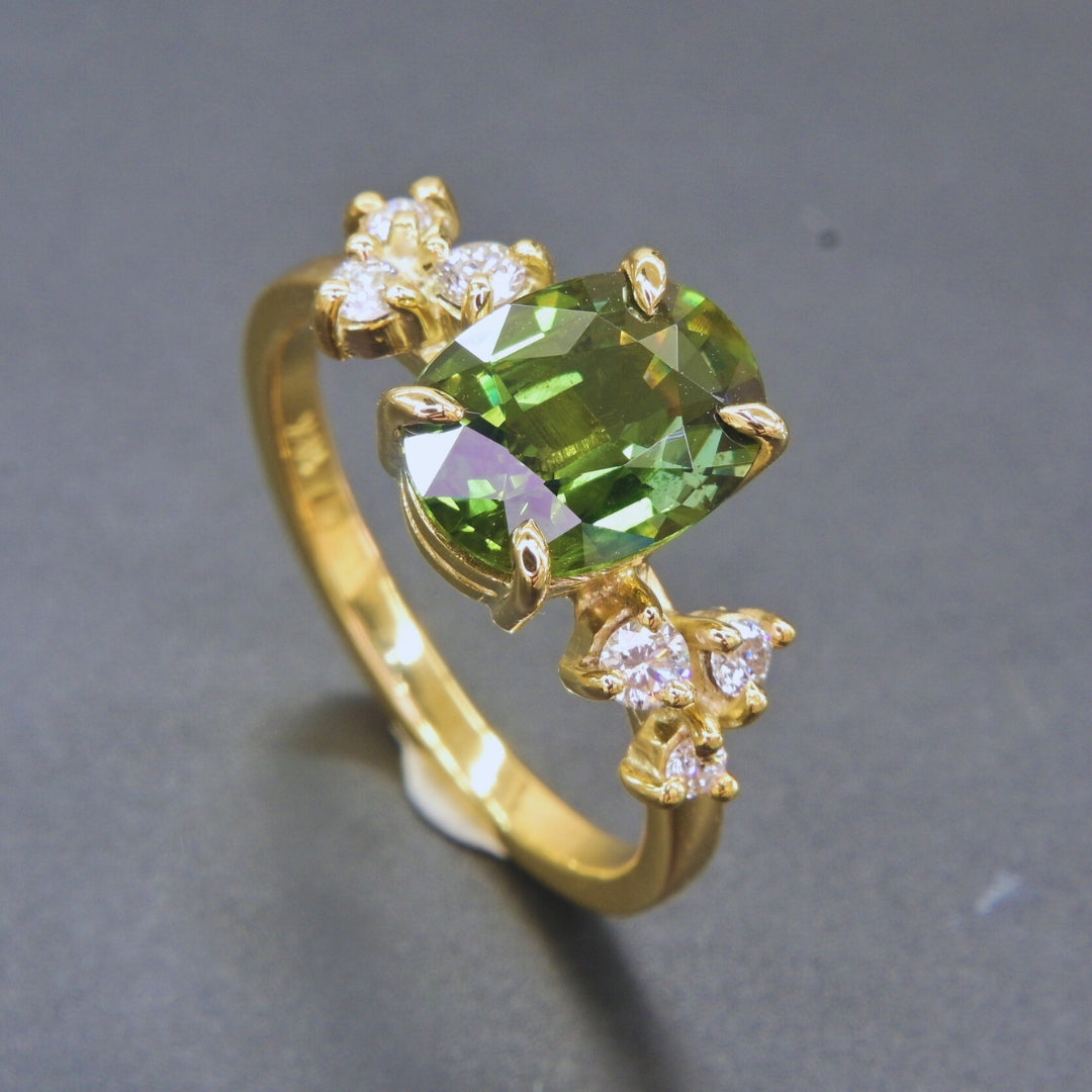 2.35 carat oval green sapphire ring with diamond side stones handmade in gold