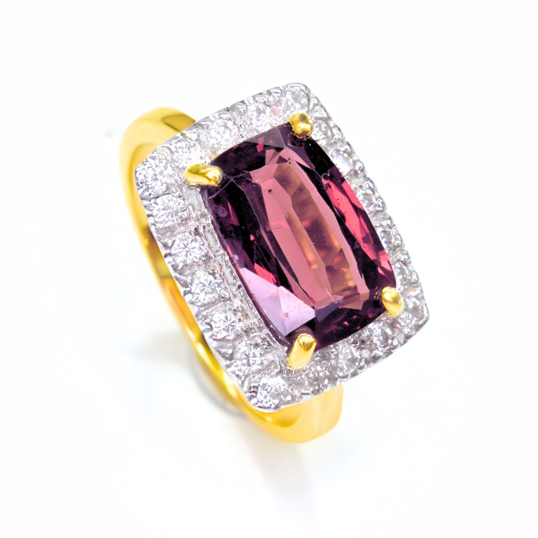 Oval cut Rhodolite Garnet gemstone ring surrounded by Moissanites