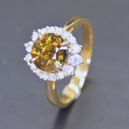 Unique green-yellow sapphire gemstone ring with diamond halo