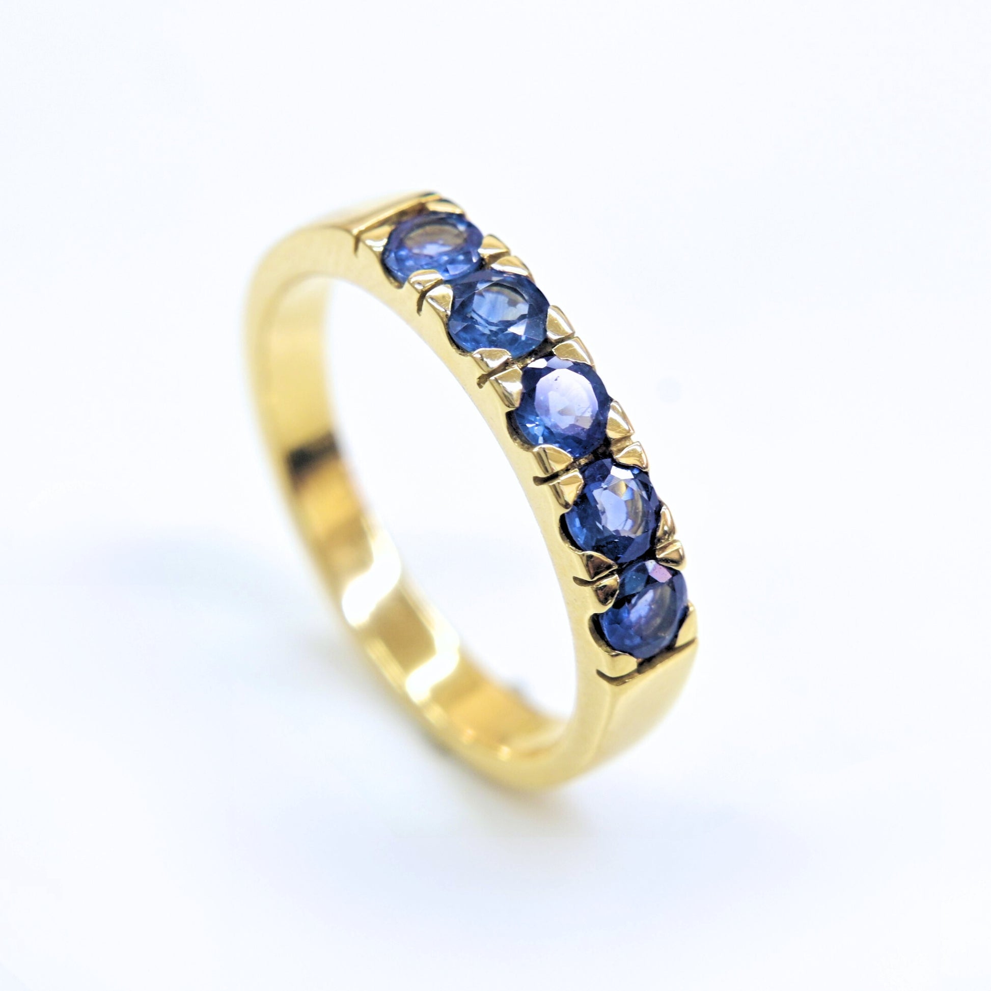 Close-up of natural blue sapphires set in 18K gold ring