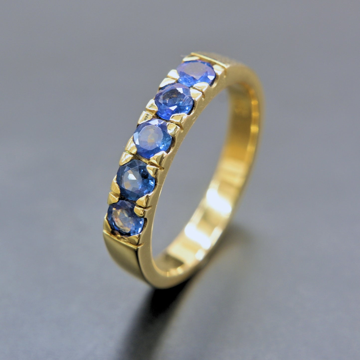 Artisan-made blue sapphire band ring in solid 18K gold
