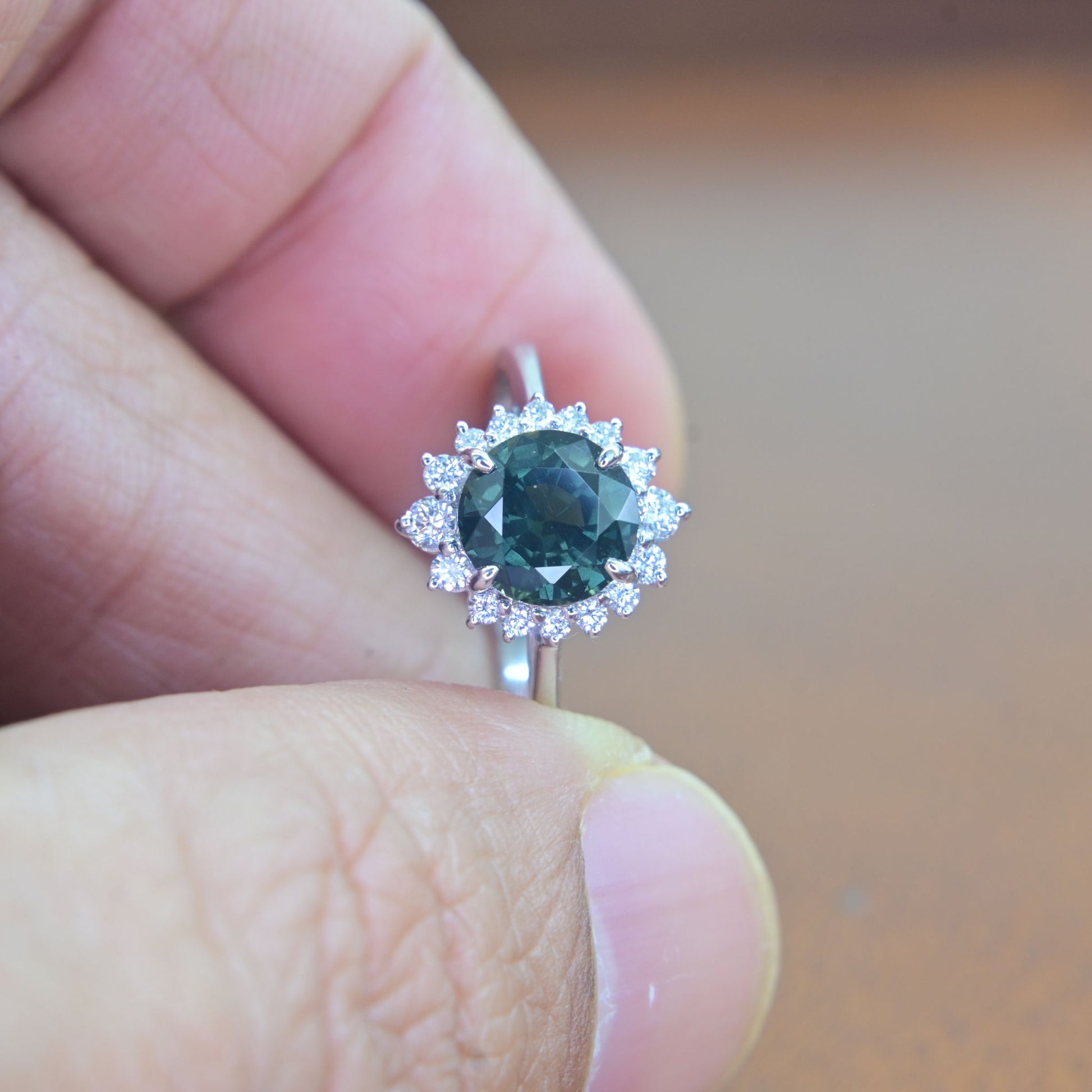 Round green sapphire engagement ring from Thailand with natural diamond halo set in 18k white gold
