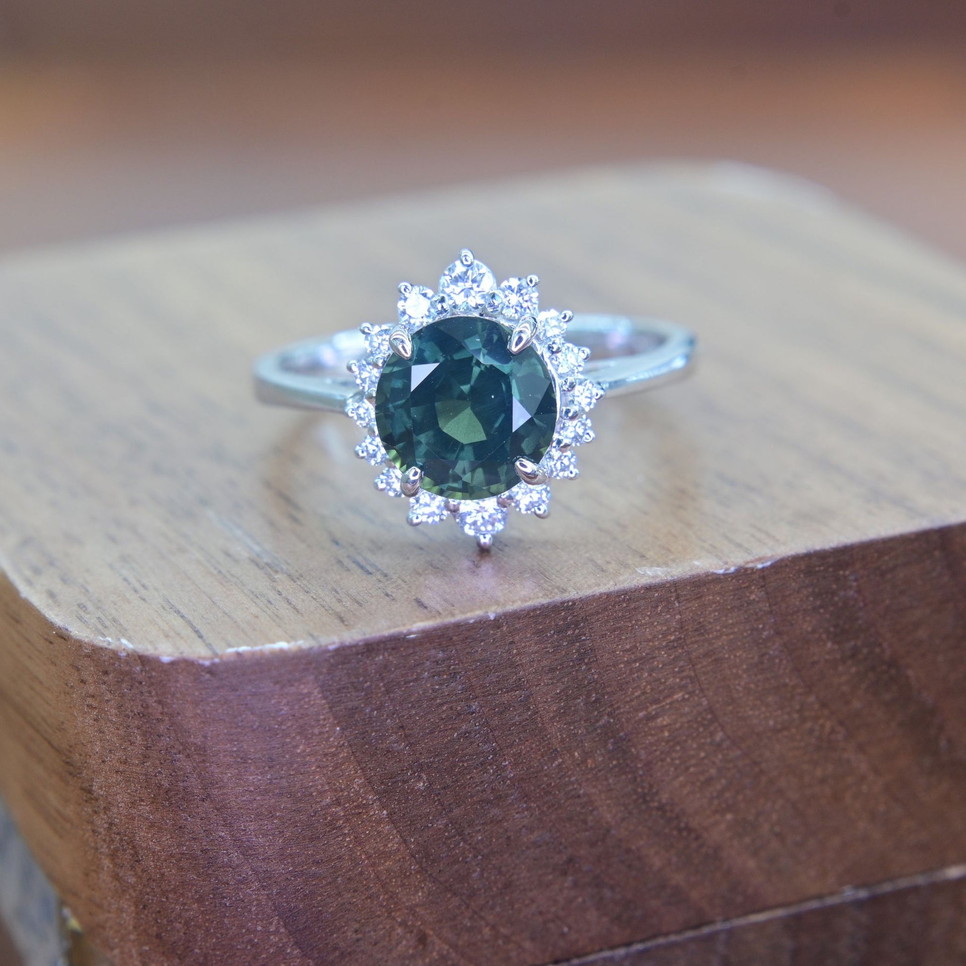 Dark forest green sapphire halo ring with sparkling natural diamonds in 18k white gold setting