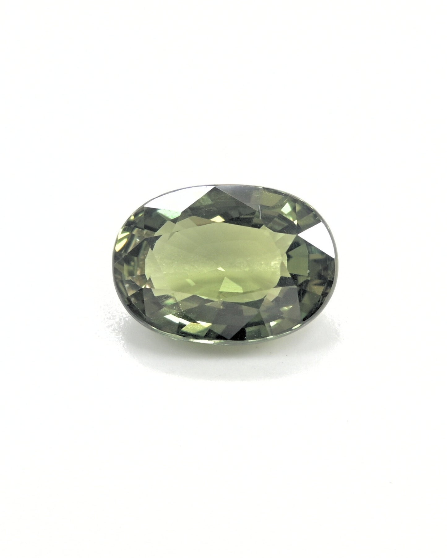 Unheated 3.32 carat olive green sapphire gemstone with an oval cut.