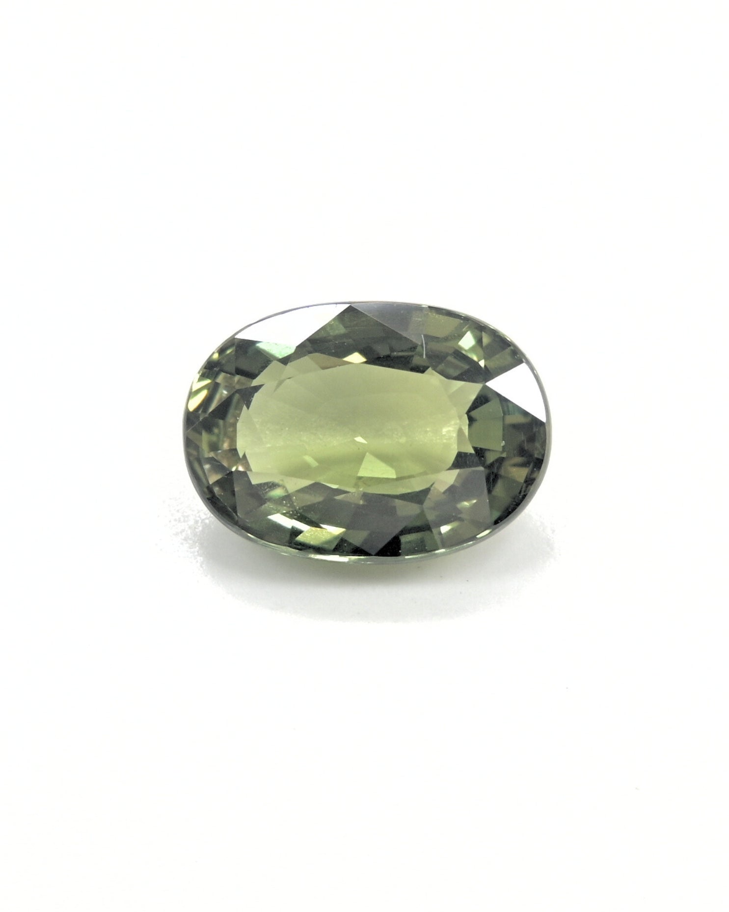 Unheated 3.32 carat olive green sapphire gemstone with an oval cut.