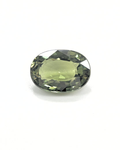 Unheated 3.32 carat olive green sapphire gemstone with an oval cut.