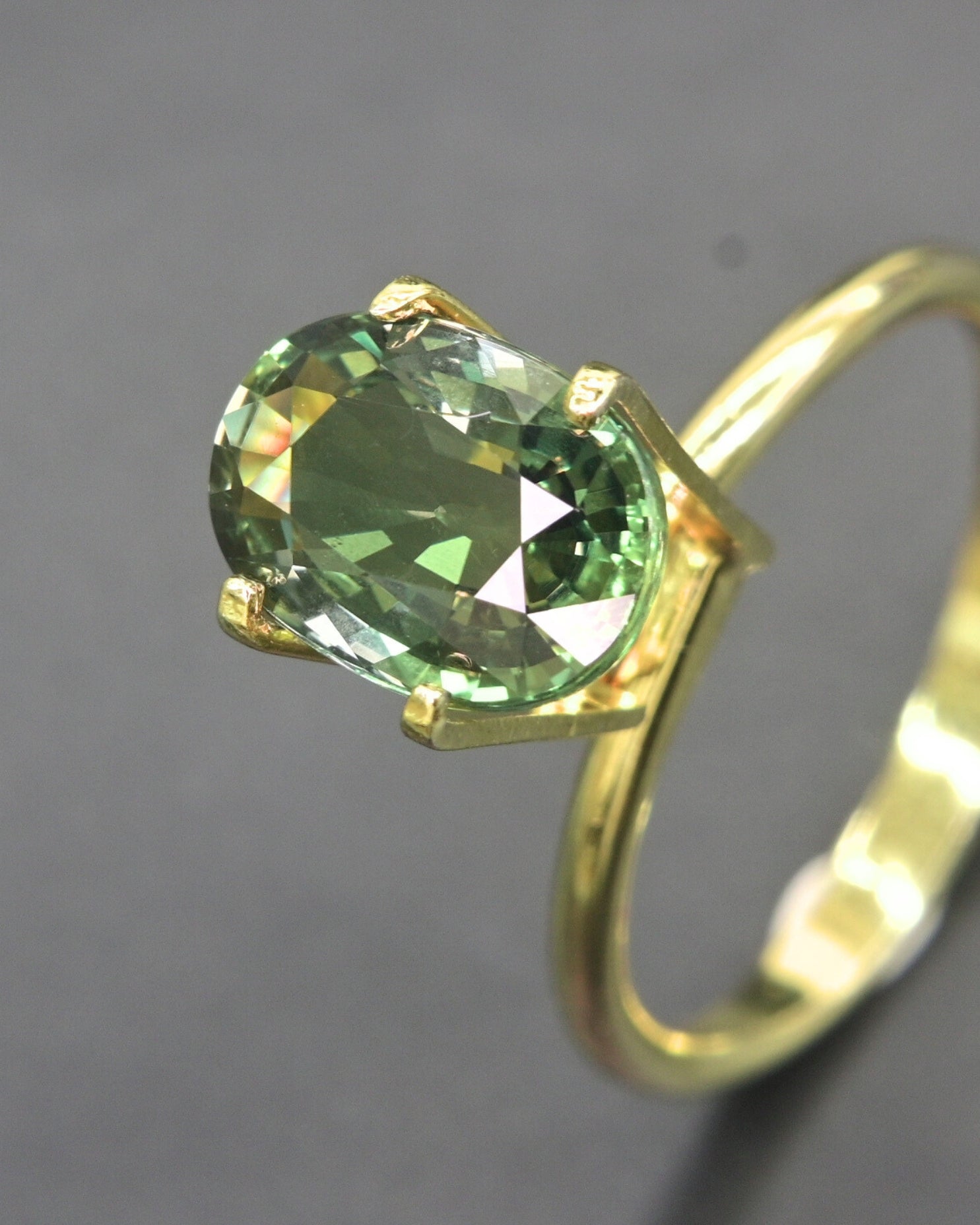 Untreated 3.32ct green sapphire from Thailand, featuring an oval facet.