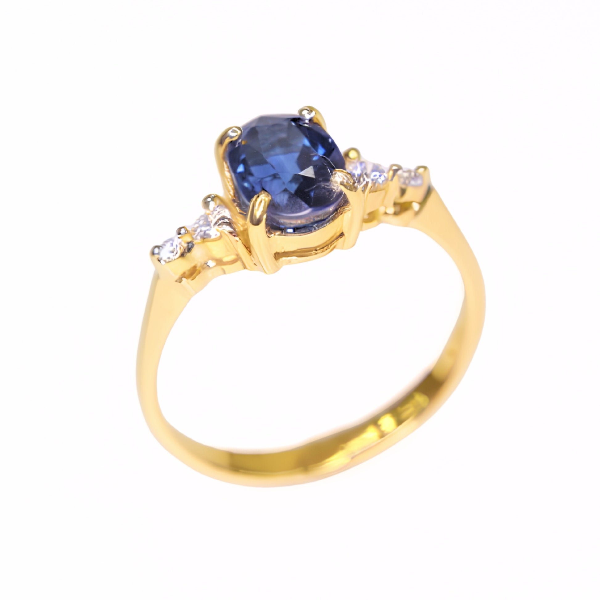 Natural oval blue sapphire ring set in solid 14K yellow gold with diamond accents