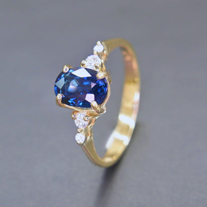 Oval natural blue sapphire with diamond accents engagement ring