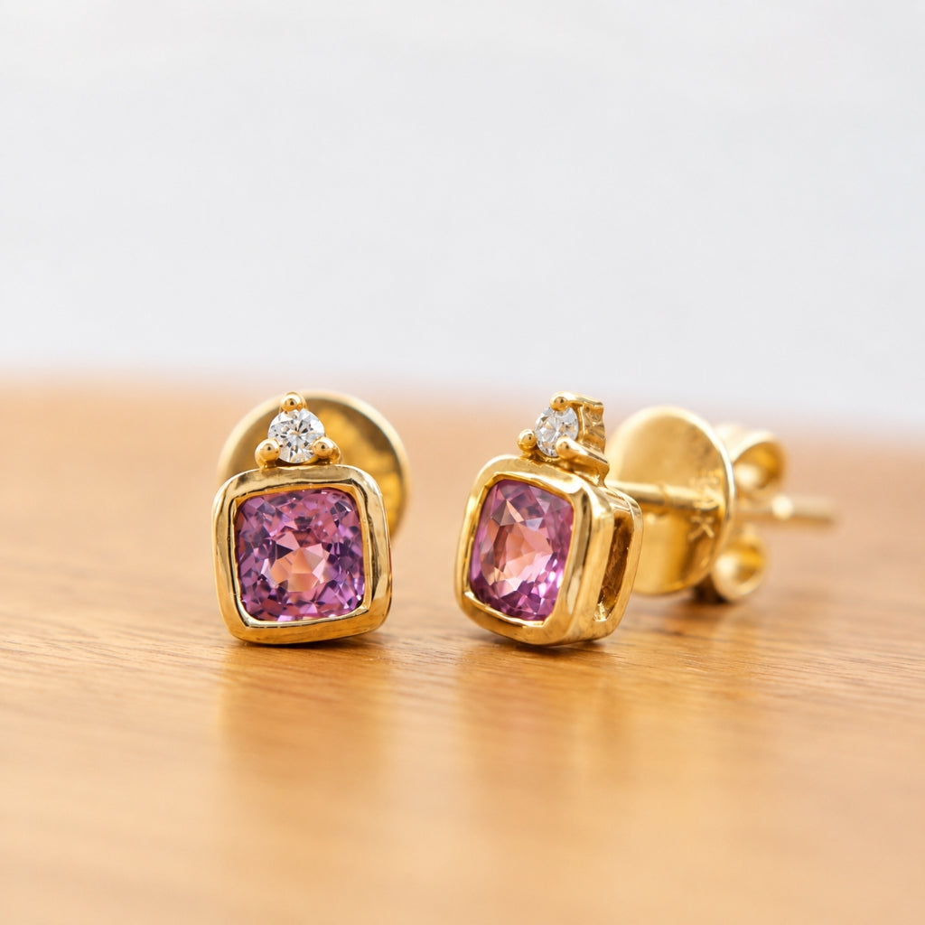 Elegant 14K gold stud earrings featuring cushion-cut pink spinels and sparkling natural diamonds.