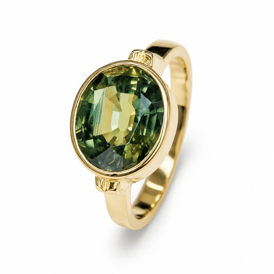 Large 3.70 carat natural Thai green sapphire ring in a 14K yellow gold bezel setting with an oval gemstone on a white background.