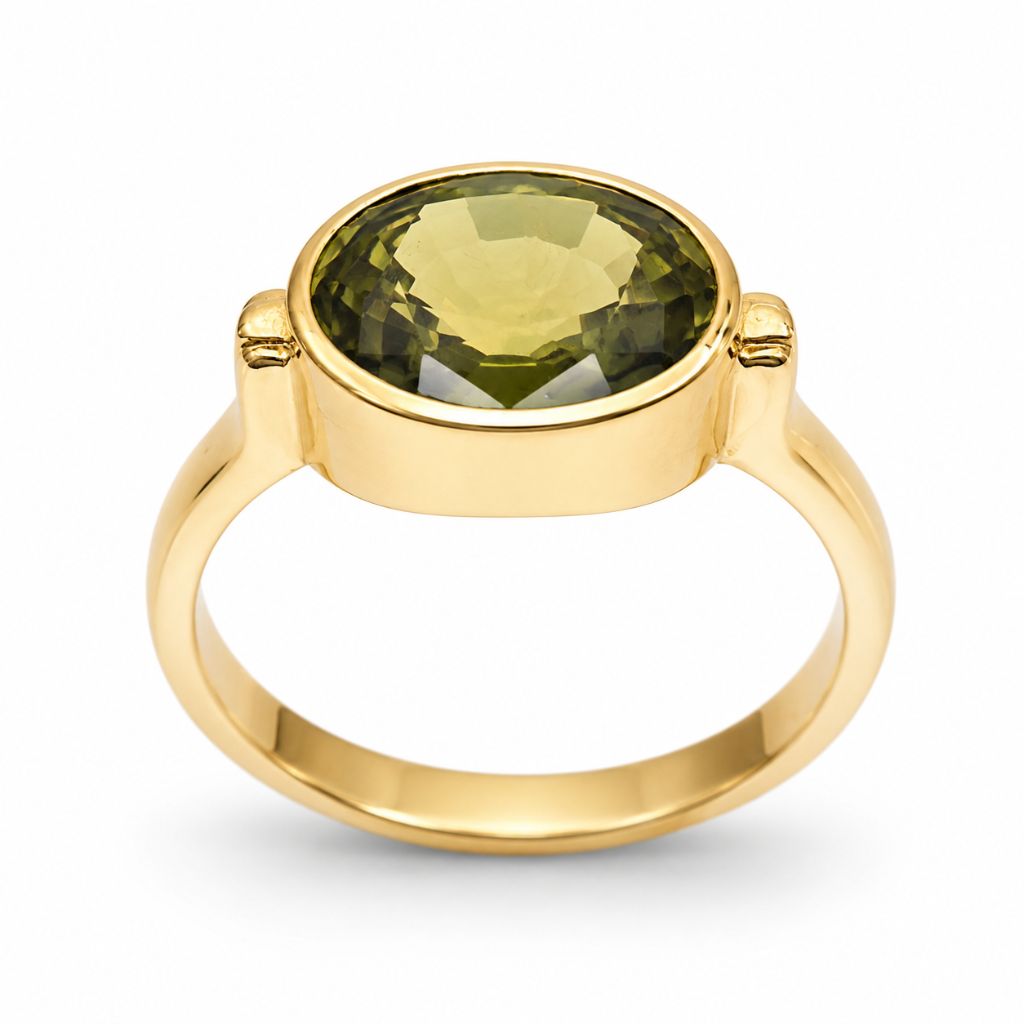 Fine jewelry featuring a natural 3.70 carat green sapphire from Thailand set in a polished 14K yellow gold bezel ring.