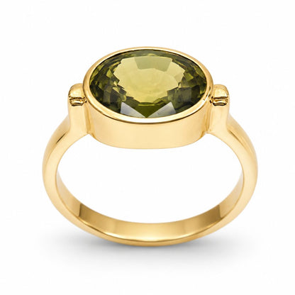 Fine jewelry featuring a natural 3.70 carat green sapphire from Thailand set in a polished 14K yellow gold bezel ring.