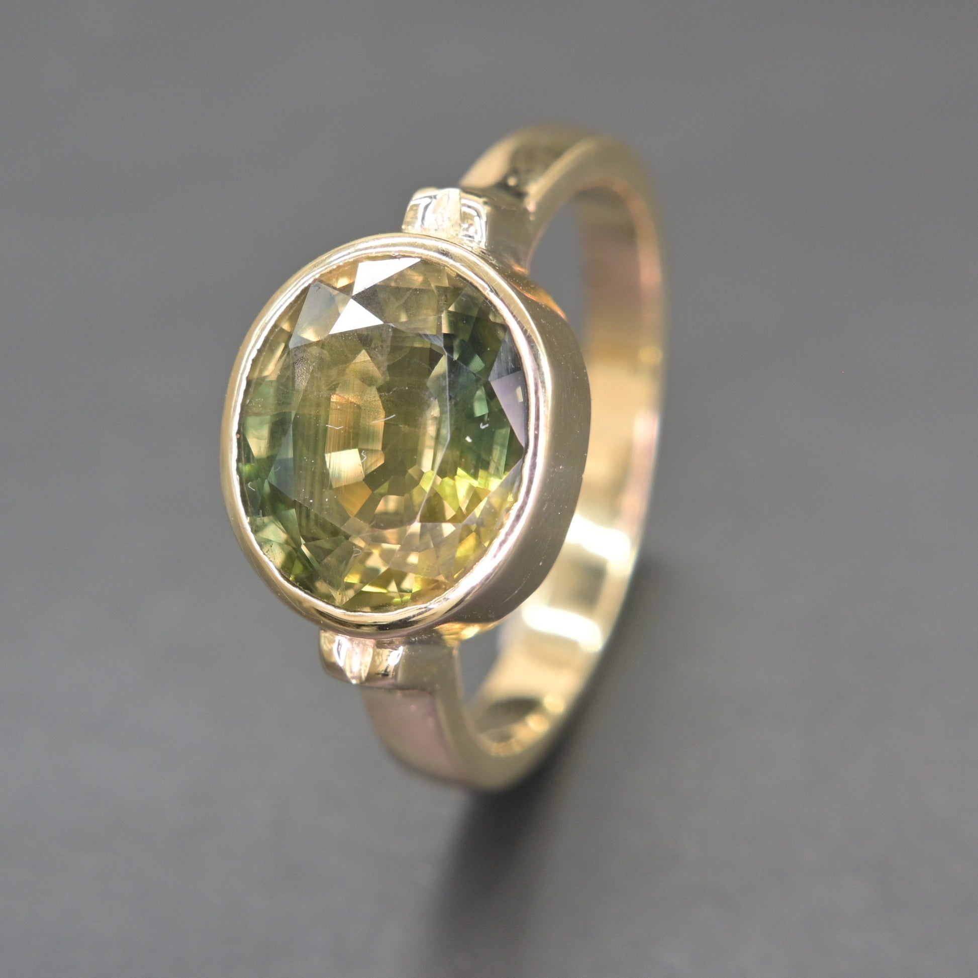 Handmade green sapphire ring from Thailand with smooth bezel setting