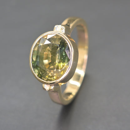 Handmade green sapphire ring from Thailand with smooth bezel setting