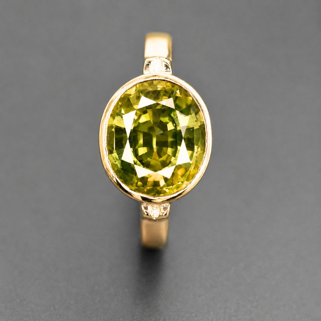 Handcrafted 14K yellow gold ring featuring a rare 3.70 carat natural Thai green sapphire with vibrant olive green color.