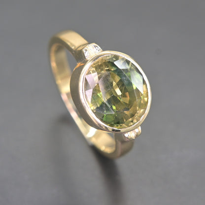 Close-up view of natural green sapphire facets in 14K gold ring