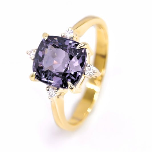 The main product image showing a unique lavender grey spinel engagement ring with four brilliant-cut natural diamonds in a 14k gold setting on a white background.
