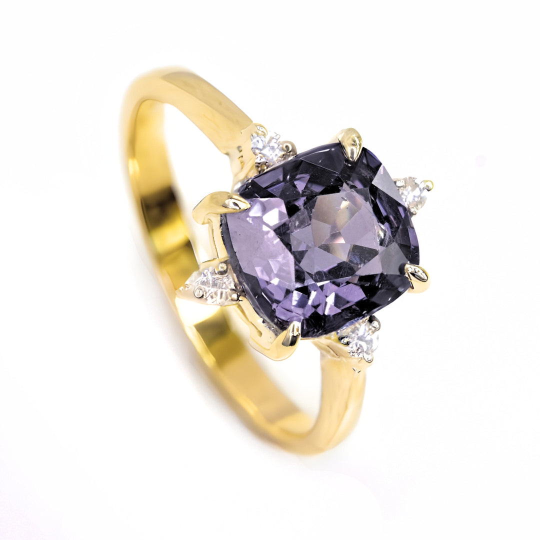 A detailed, high-resolution view highlighting the unheated cushion-cut lavender grey spinel, showcasing its rich purple and grey tones and expert faceting.