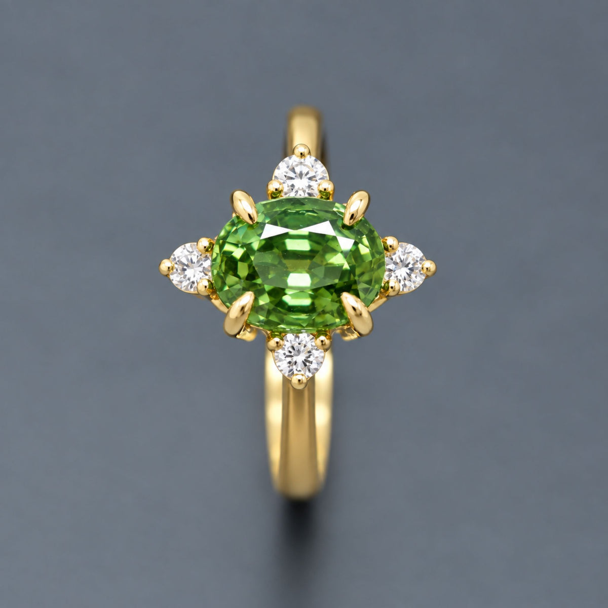 Thai green sapphire engagement ring featuring a vivid faceted green center sapphire and diamond cluster
