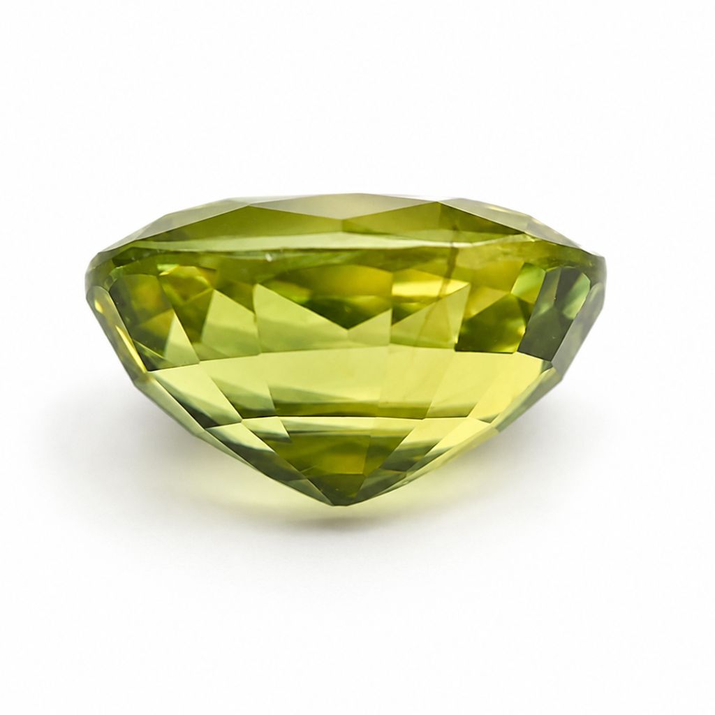 Natural unheated Thai green sapphire weighing 1.19 carats photographed at an angled view highlighting its oval cut.