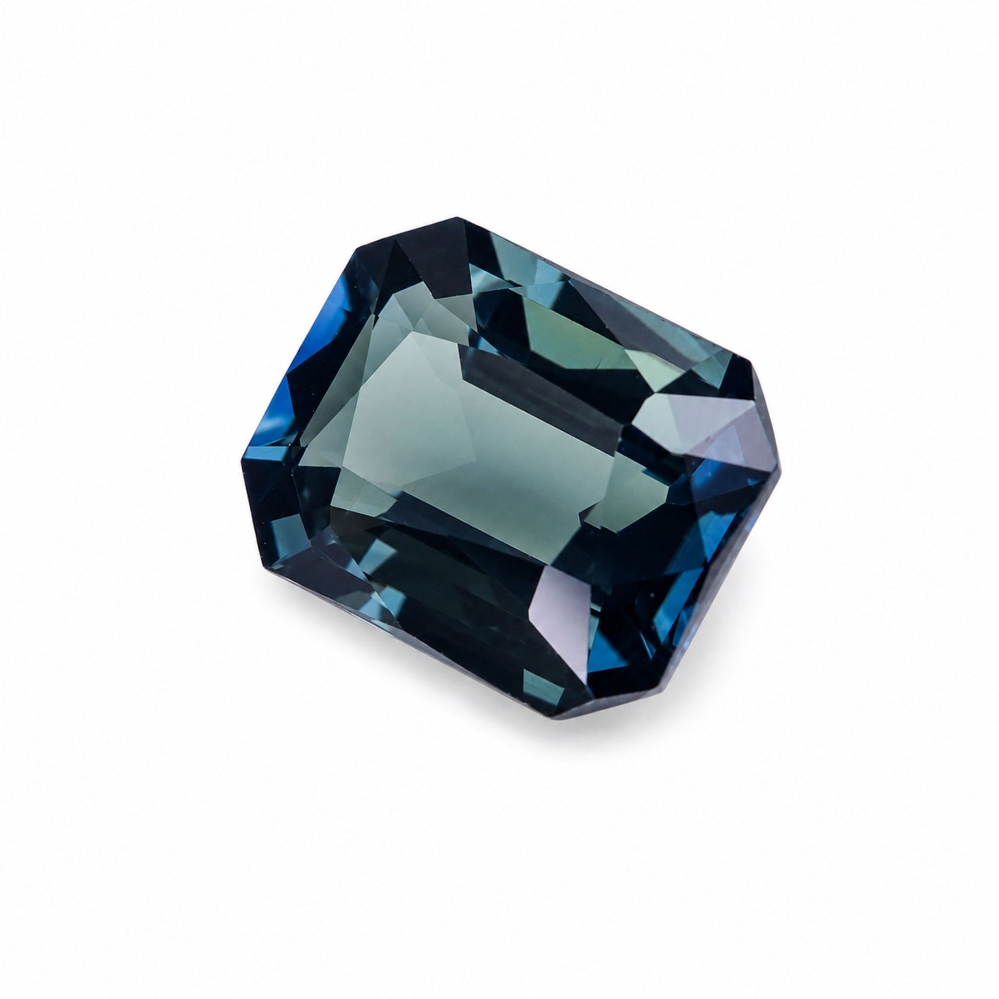 A faceted rectangular unheated blue-green sapphire with a cushion-cut shape, displayed on a clean white background.